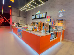 Vibrant orange Cafe and Snack Kiosk design for AmexiQ at Silicon Central Mall, Dubai. High-impact mall Food Kiosk fit-out project.